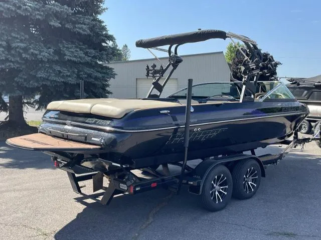 Slide: The Image of 2023 Sanger V237 SX boat on a trailer, parked outdoors. - 5