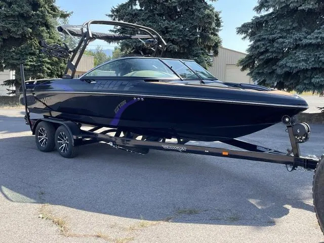 Slide: The Image of 2023 Sanger V237 SX boat on a trailer, parked outdoors. - 7