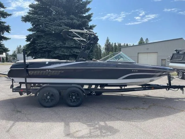 The Image of 2023 Sanger V-215 SX boat on trailer, parked outdoors. - 0