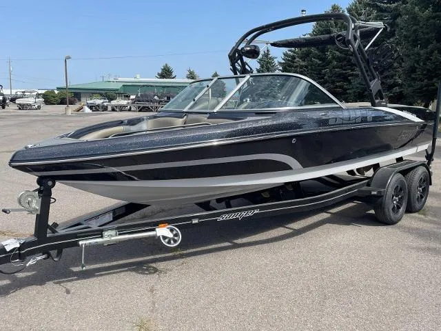 Slide: The Image of 2023 Sanger V-215 SX black boat on trailer in parking lot. - 1