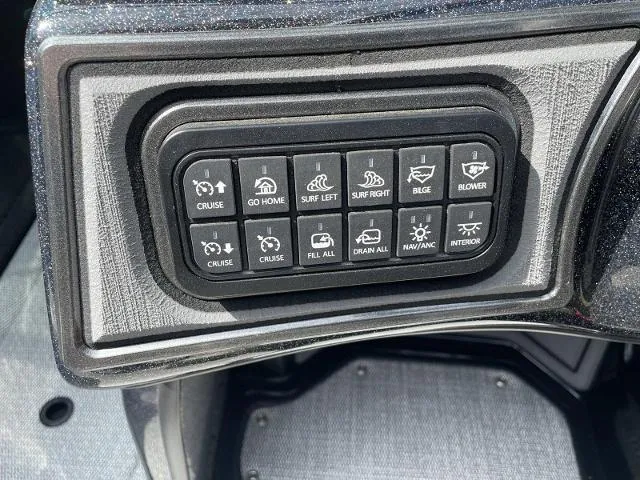 Slide: The Image of 2023 Sanger V-215 SX boat control panel with various function buttons. - 7