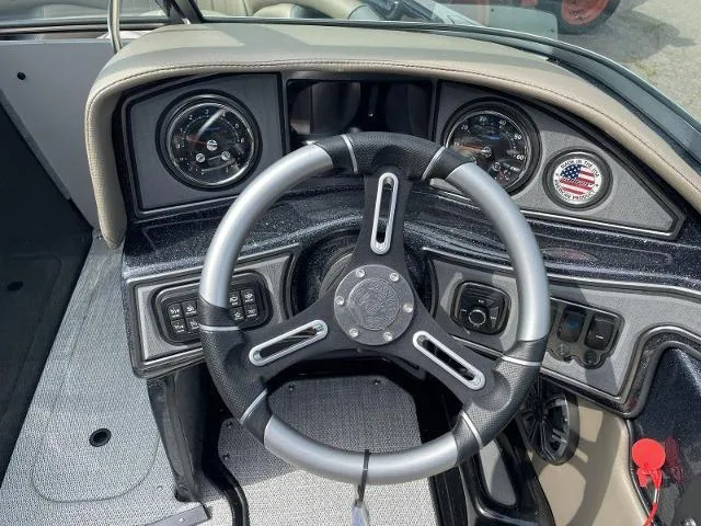 Slide: The Image of 2023 Sanger V-215 SX boat dashboard with steering wheel and gauges. - 9