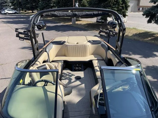 Slide: The Image of 2023 Sanger V215 Special boat interior with beige seating and black accents. - 7