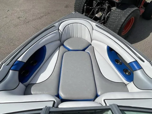 Slide: The Image of 2023 Sanger V215 SX boat interior with gray and blue cushioned seating. - 11