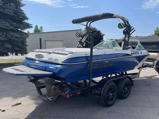 Slide: The Image of 2023 Sanger V215 SX boat on trailer, blue and white, parked outdoors. - 5