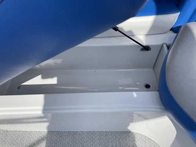 Slide: The Image of 2023 Sanger V215 SX boat storage compartment with blue and white interior. - 8