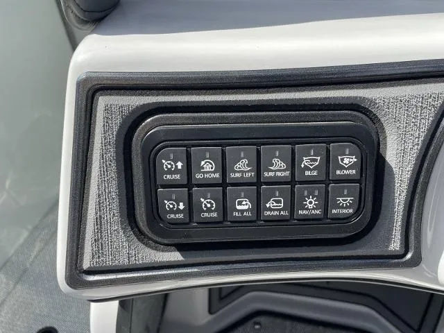 Slide: The Image of Control panel of a 2023 Sanger V215 SX boat with various function buttons. - 9