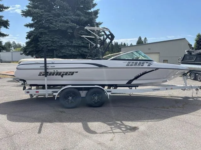The Image of 2023 Sanger V237 SX boat on a trailer in a parking lot. - 0