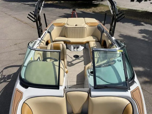 Slide: The Image of 2023 Sanger V237 SX boat interior with beige seating and open windshield. - 11