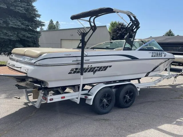 Slide: The Image of 2023 Sanger V237 SX boat on a trailer, parked outdoors. - 6