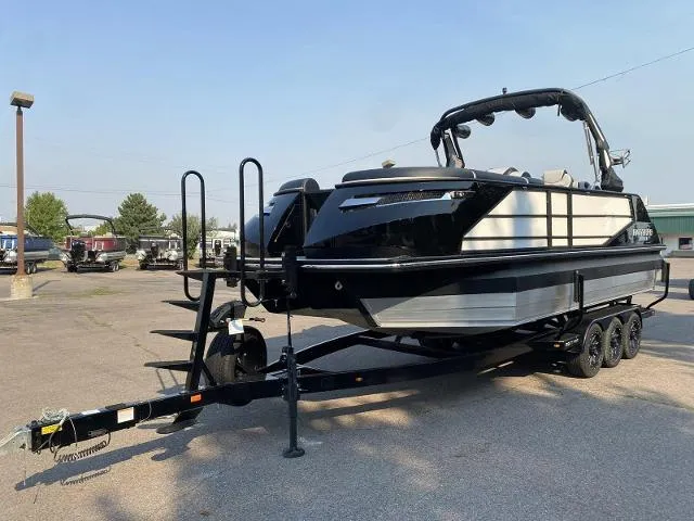 Slide: The Image of 2023 Montara Surf Boss 202 boat on a trailer in a parking lot. - 1