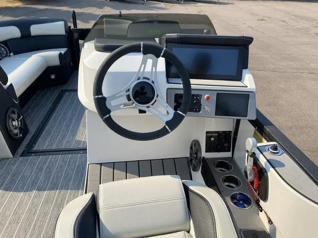 Slide: The Image of 2023 Montara Surf Boss 202 boat cockpit with steering wheel, touchscreen, and seating. - 10