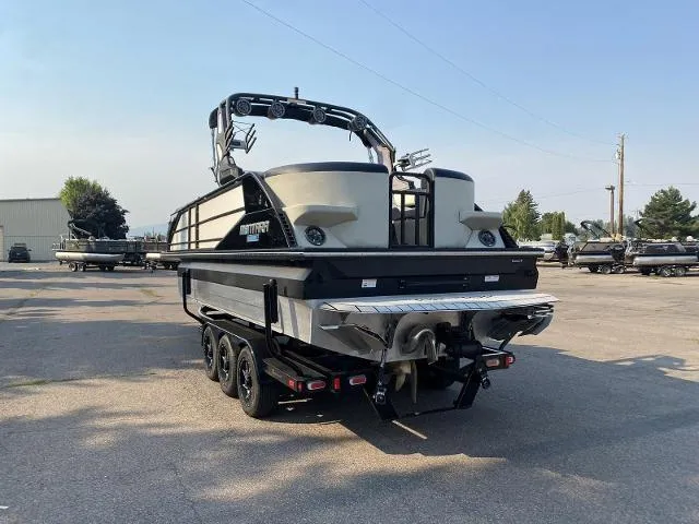 Slide: The Image of 2023 Montara Surf Boss 202 boat on a trailer in a parking lot. - 2
