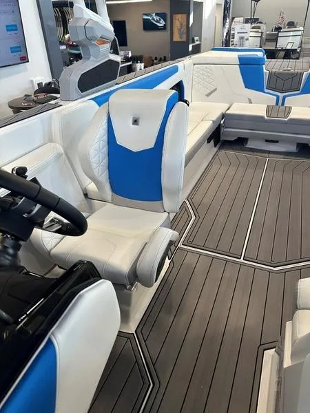 Slide: The Image of 2024 Nautique GS24 boat interior with white and blue seating, modern design. - 6
