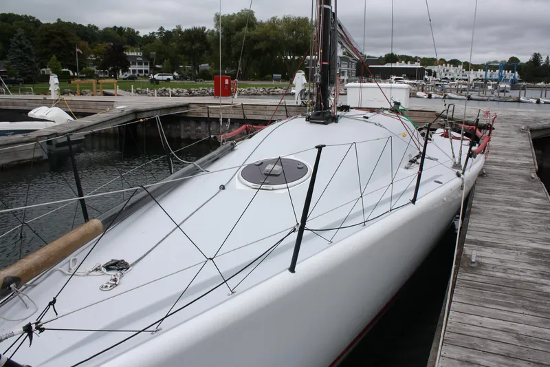 Slide: The Image of 2004 Farr 40 sailboat docked at a marina, showcasing sleek design and rigging. - 10