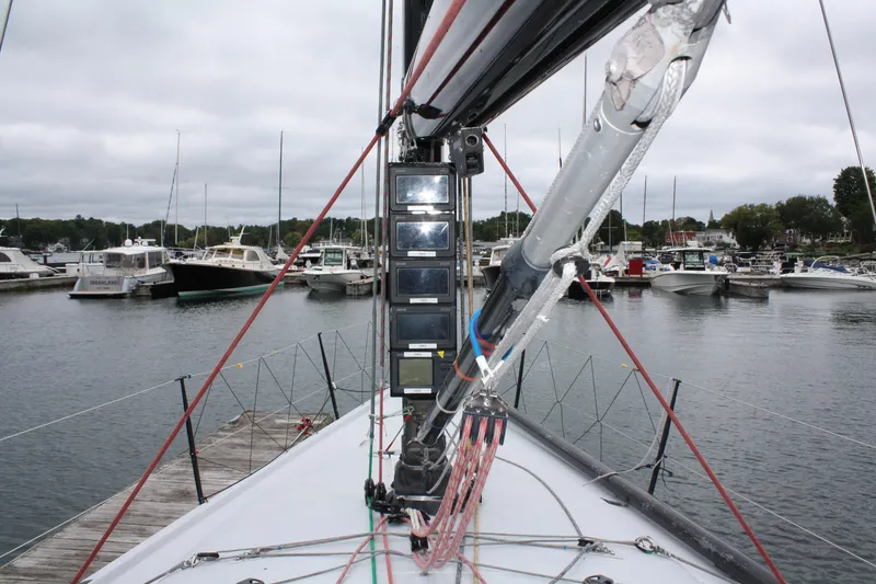 Slide: The Image of Farr 40 sailboat from 2004 docked in a marina, showcasing mast and rigging. - 19