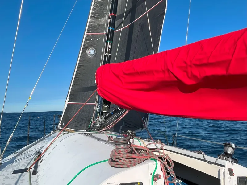 Slide: The Image of Sailing on a 2004 Farr 40 yacht with vibrant red sail cover and clear blue skies. - 24