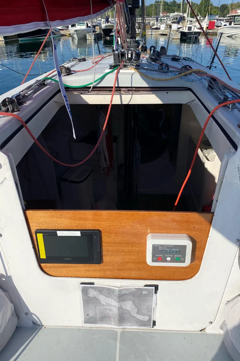 Slide: The Image of 2004 Farr 40 sailboat cockpit with control panel and marina view. - 25