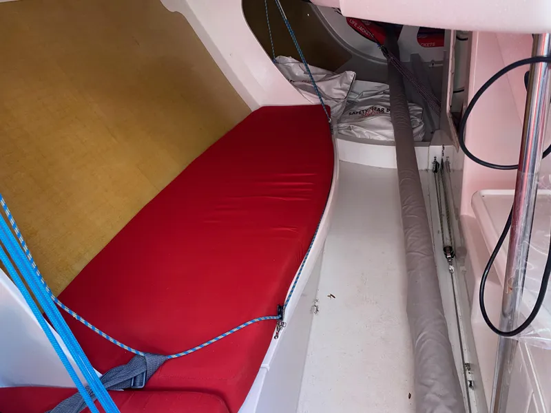 Slide: The Image of Interior of 2004 Farr 40 sailboat with red cushion and rigging. - 27
