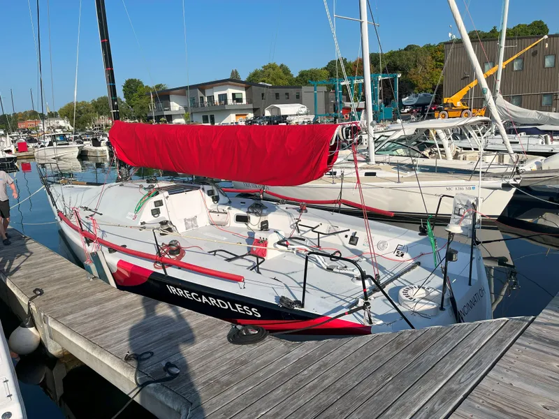 Slide: The Image of Farr 40 sailboat from 2004 docked with red sail cover, named "Regardless." - 3