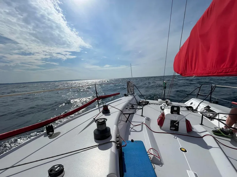 Slide: The Image of Sailing on a 2004 Farr 40 yacht with red sails under a bright sky. - 31