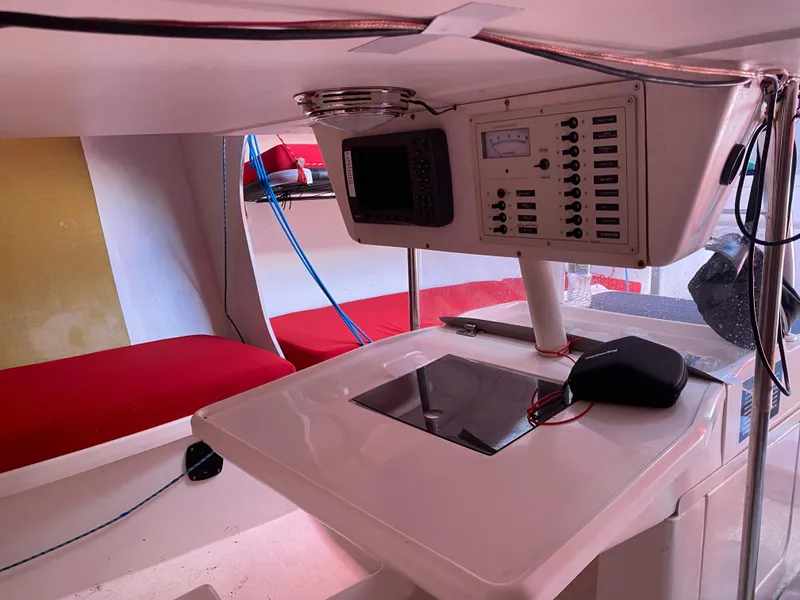 Slide: The Image of Interior of a 2004 Farr 40 sailboat with navigation equipment and red seating. - 32