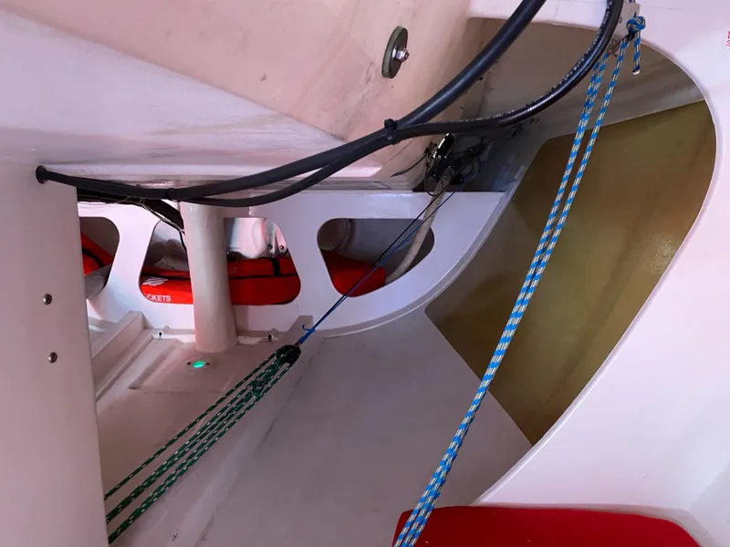 Slide: The Image of Interior of 2004 Farr 40 sailboat with ropes and red cushions. - 33