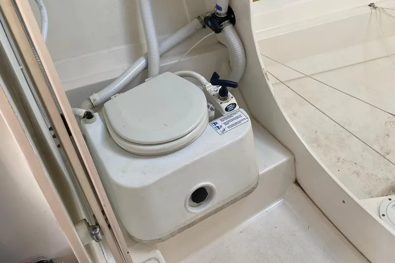 Slide: The Image of Boat toilet in a 2004 Farr 40 yacht, featuring compact design and plumbing. - 38