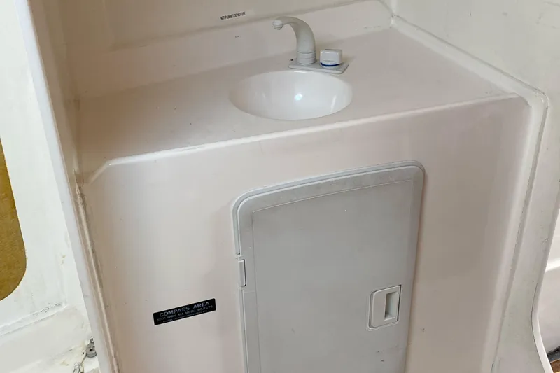 Slide: The Image of Compact sink and cabinet in a 2004 Farr 40 yacht bathroom. - 39