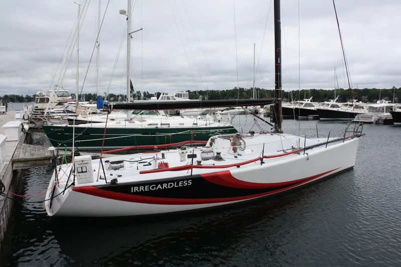 Slide: The Image of Farr 40 sailboat from 2004 named "Irregardless" docked at a marina. - 4