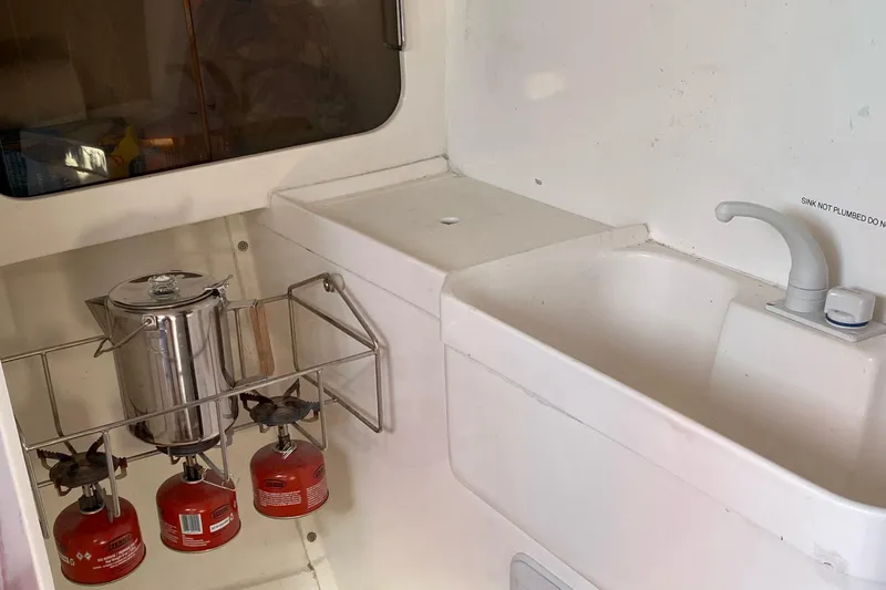 Slide: The Image of Compact kitchen area in a 2004 Farr 40 sailboat with stove and sink. - 40