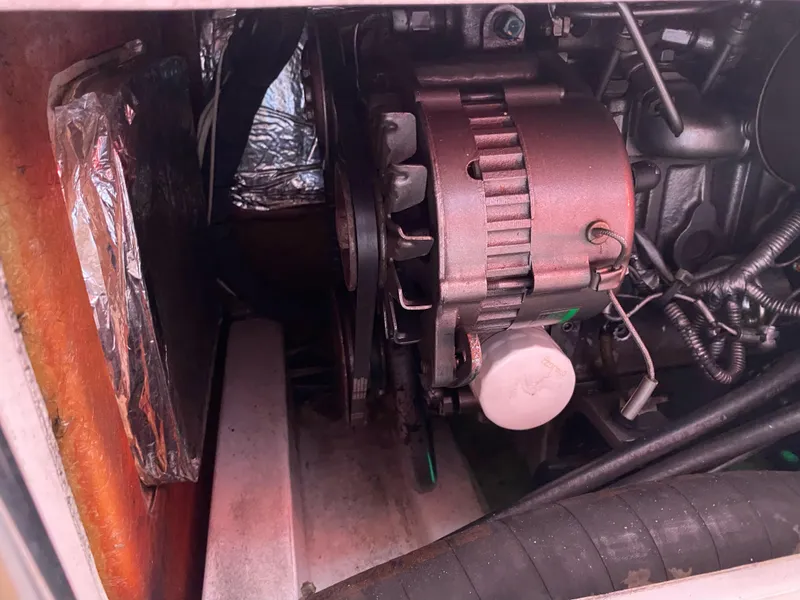 Slide: The Image of Engine compartment of a 2004 Farr 40 sailboat, showing alternator and wiring. - 47