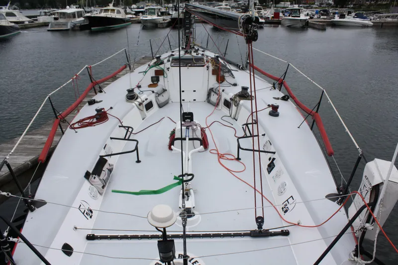 Slide: The Image of Farr 40 sailboat deck, 2004 model, docked in a marina with various equipment visible. - 6