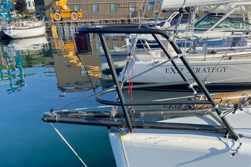 Slide: The Image of Farr 40 sailboat from 2004 docked in a marina, featuring a sturdy metal frame. - 9