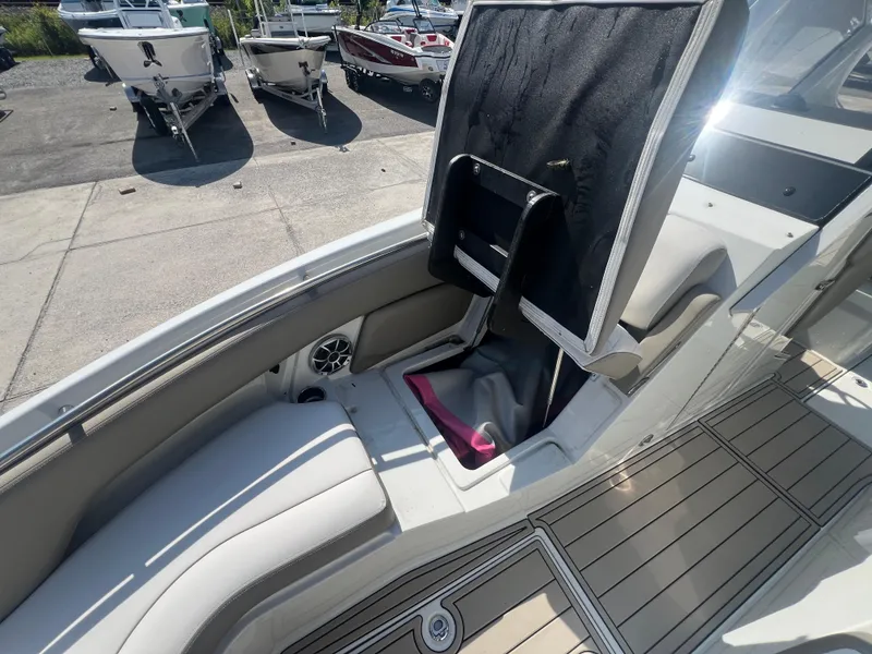 Slide: The Image of 2023 Finseeker 280 DC boat interior with seating and storage compartment. - 11