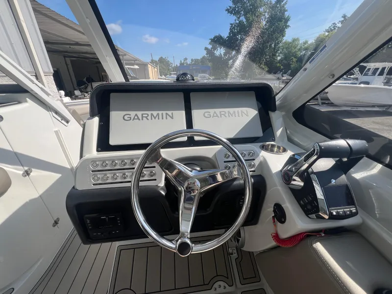 Slide: The Image of 2023 Finseeker 280 DC boat helm with dual Garmin displays and modern controls. - 13