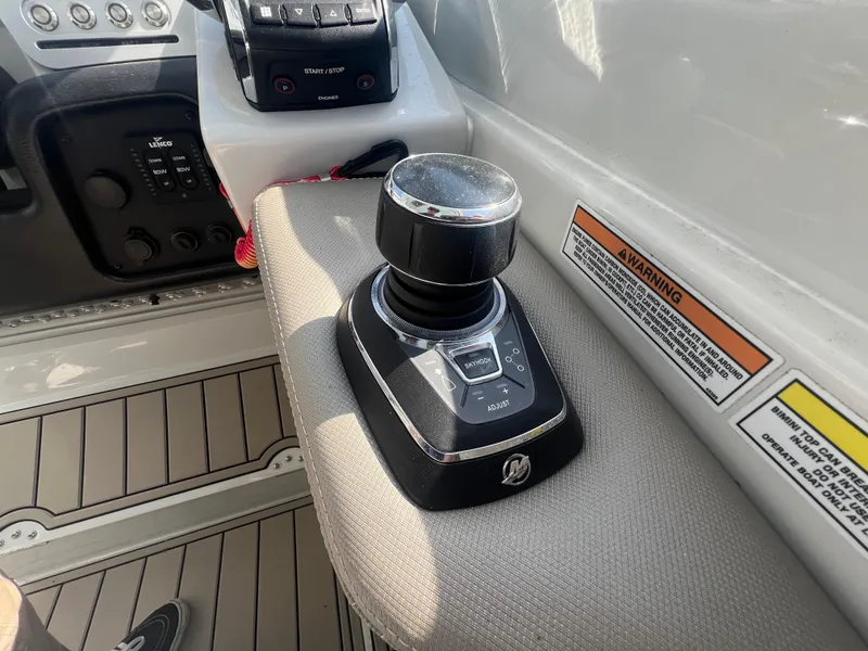 Slide: The Image of Control panel of 2023 Finseeker 280 DC boat with joystick and warning labels. - 18