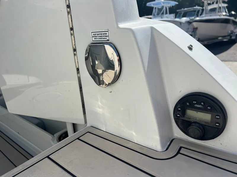 Slide: The Image of 2023 Finseeker 280 DC boat detail with control panel and water system warning. - 27