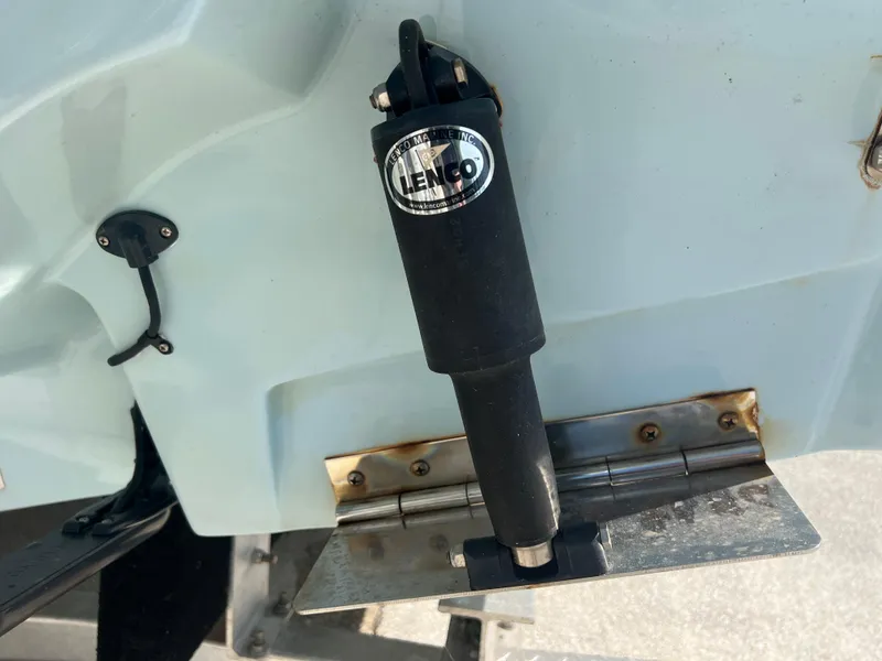Slide: The Image of Close-up of a Lenco trim tab actuator on a 2023 Finseeker 280 DC boat. - 28