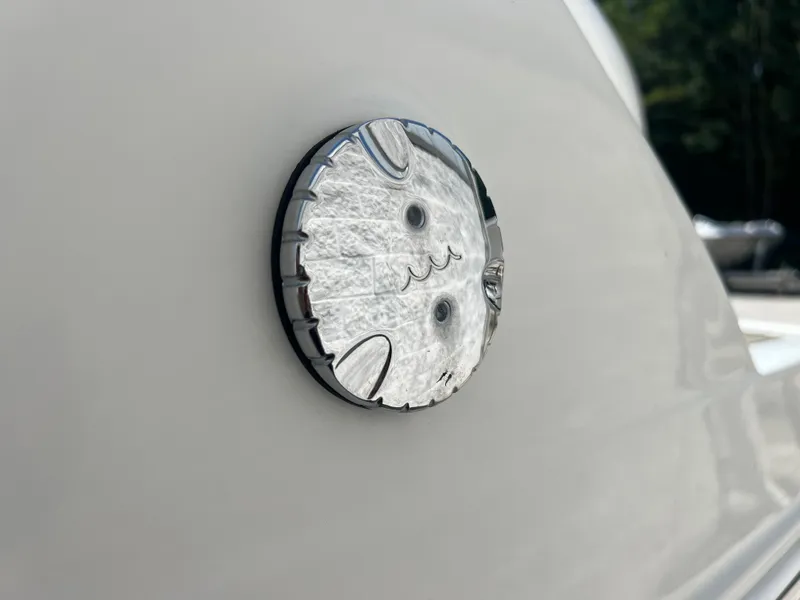Slide: The Image of Close-up of a 2023 Finseeker 280 DC boat detail with a circular chrome fixture. - 30