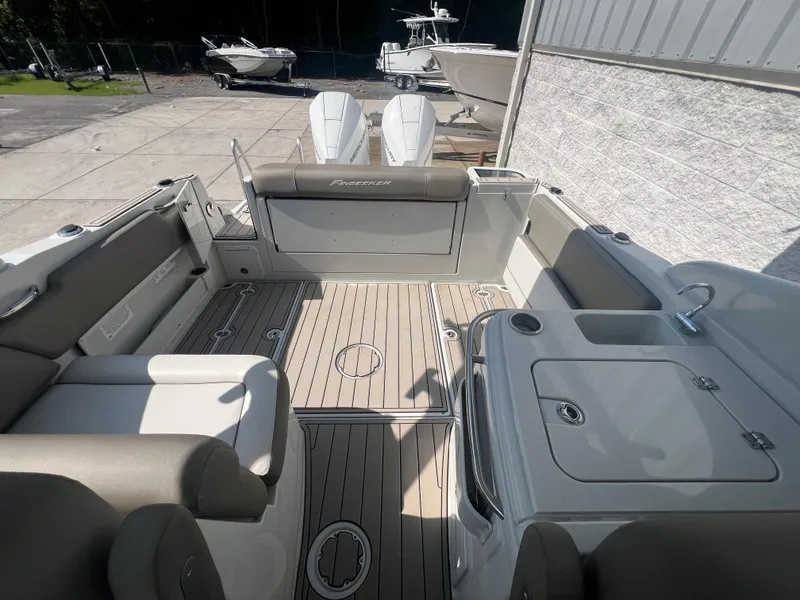 Slide: The Image of 2023 Finseeker 280 DC boat interior with seating and deck view. - 7