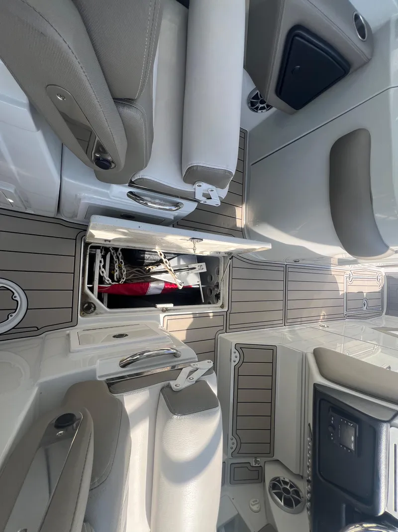 Slide: The Image of 2023 Finseeker 280 DC boat interior with open storage compartments and seating. - 9