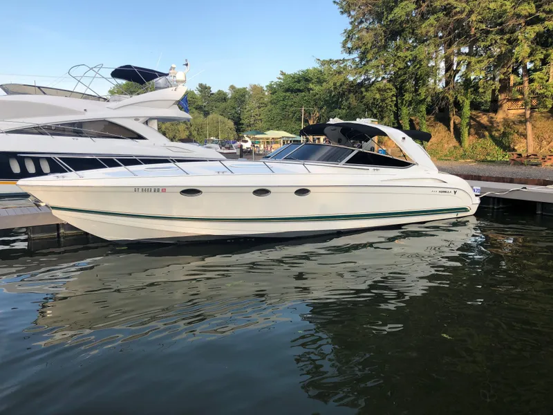 Slide: The Image of 1999 Formula 400 Super Sport boat docked at a marina. - 10