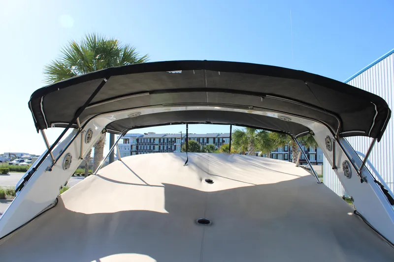 Slide: The Image of 1999 Formula 400 Super Sport boat with black canopy and beige deck. - 13