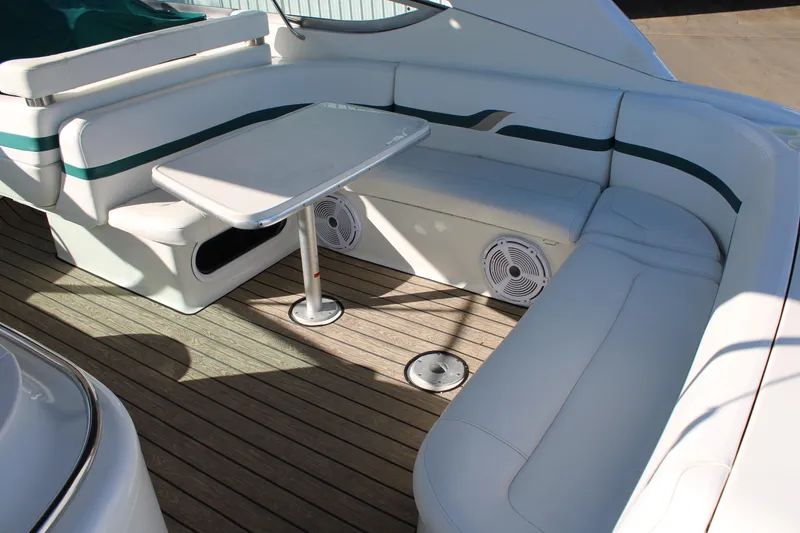 Slide: The Image of 1999 Formula 400 Super Sport boat interior with white seating and table. - 15