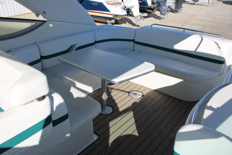 Slide: The Image of 1999 Formula 400 Super Sport boat interior with white seating and table. - 16