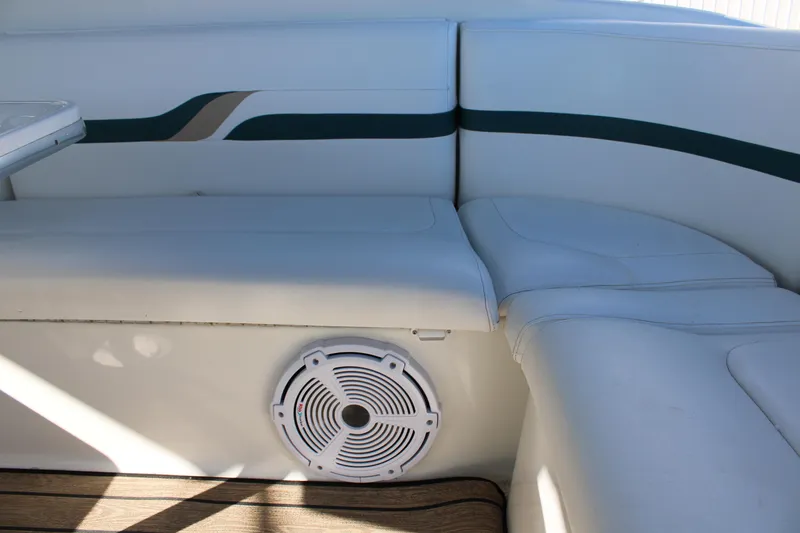 Slide: The Image of 1999 Formula 400 Super Sport boat interior with white seating and speaker. - 18