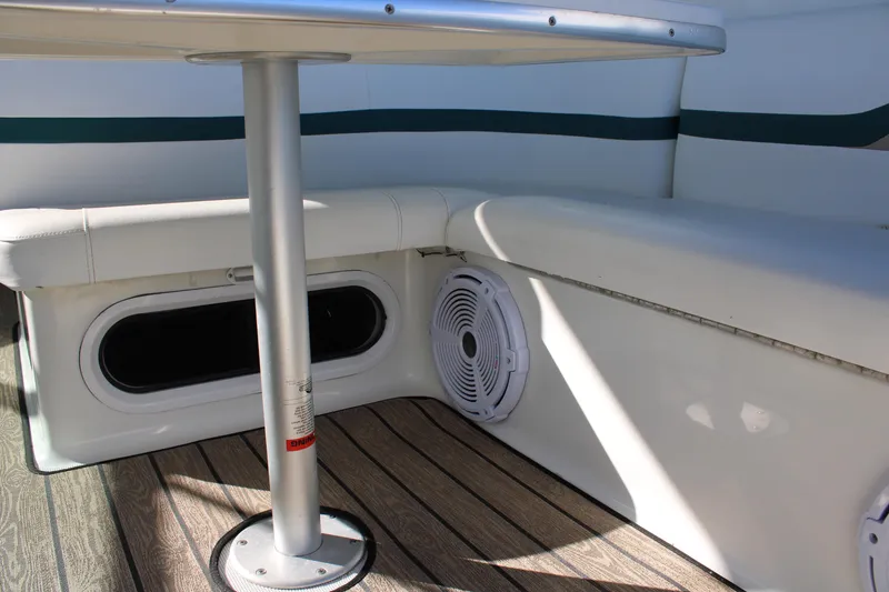 Slide: The Image of 1999 Formula 400 Super Sport boat interior with white seating and table. - 19