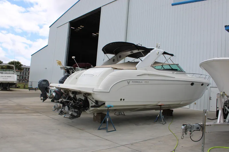 Slide: The Image of 1999 Formula 400 Super Sport boat in a marina storage area. - 2