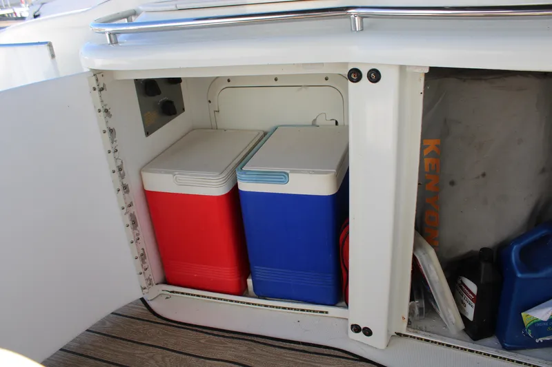 Slide: The Image of Storage compartment with red and blue coolers on a 1999 Formula 400 Super Sport boat. - 23